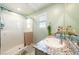 Bathroom featuring walk-in shower, granite countertops, and decorative plants at 440 Blue Lark Dr, Henderson, NV 89011
