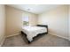 Carpeted bedroom with a bed, a window with blinds, and neutral colored walls at 440 Blue Lark Dr, Henderson, NV 89011