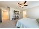 Spacious main bedroom featuring ceiling fan, shelving, and ensuite bathroom at 440 Blue Lark Dr, Henderson, NV 89011