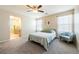 Bright main bedroom with a ceiling fan and ensuite bathroom providing natural light at 440 Blue Lark Dr, Henderson, NV 89011