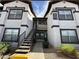 Exterior of a two-story apartment building featuring multiple windows and a central staircase leading to upper units at 45 Maleena Mesa St # 1321, Henderson, NV 89074