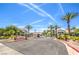 Welcoming Traverse Point gated community entrance with lush landscaping and palm trees under a clear blue sky at 45 Maleena Mesa St # 1321, Henderson, NV 89074