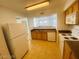 Functional kitchen with appliances, tile flooring, and wood cabinets at 45 Maleena Mesa St # 1321, Henderson, NV 89074