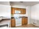 Efficient kitchen featuring white appliances, wood cabinets, and laminate countertops perfect for daily cooking at 45 Maleena Mesa St # 1321, Henderson, NV 89074