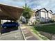 View of covered parking with grassy landscaped areas surrounding modern apartment buildings at 45 Maleena Mesa St # 1321, Henderson, NV 89074