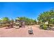 Community playground with slides and swings under a blue sky at 45 Maleena Mesa St # 1321, Henderson, NV 89074