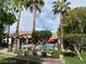 View of a community pool with palm trees surrounding and red umbrellas at 45 Maleena Mesa St # 1321, Henderson, NV 89074