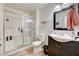 Bathroom featuring a glass door walk-in shower, dark vanity, and neutral-colored floor tiles at 5000 Red Rock St # 248, Las Vegas, NV 89118