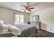 Comfortable bedroom features wood floors, ceiling fan, and plenty of natural light from a large window at 5000 Red Rock St # 248, Las Vegas, NV 89118