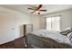 Bedroom featuring a window with natural light, ceiling fan, wood flooring and neutral decor at 5000 Red Rock St # 248, Las Vegas, NV 89118