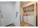 View of the entryway with a white door and a laundry closet with a white washer and dryer at 5000 Red Rock St # 248, Las Vegas, NV 89118