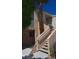 Condo building featuring stucco exterior, outdoor staircase, and mature landscaping at 5000 Red Rock St # 248, Las Vegas, NV 89118