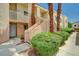 Charming condo exterior with landscaped walkway, stairs, and courtyard featuring mature palm trees at 5000 Red Rock St # 248, Las Vegas, NV 89118