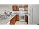 Traditional kitchen with granite countertops, stainless steel sink, and white appliances, perfect for cooking at 5000 Red Rock St # 248, Las Vegas, NV 89118