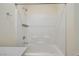 Bathroom featuring a shower and tub, white wall tiles, and stainless steel fixtures at 5398 Robinera Ct, Las Vegas, NV 89166