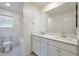 Contemporary bathroom with dual sinks, quartz countertops, and shower-tub combo provides relaxation at 5398 Robinera Ct, Las Vegas, NV 89166