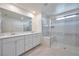 Modern bathroom features double vanity, and a frameless glass shower, offering sleek style at 5398 Robinera Ct, Las Vegas, NV 89166