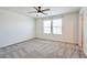 Bedroom features carpeted floors, a ceiling fan with a light, and bright windows to let light in at 5398 Robinera Ct, Las Vegas, NV 89166