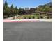Street view of the community park with mature trees and lush green lawn at 5398 Robinera Ct, Las Vegas, NV 89166