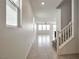 Bright entryway with tile flooring, staircase, and plenty of natural light at 5398 Robinera Ct, Las Vegas, NV 89166