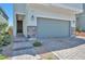 Close up of charming two-story home featuring an attached garage and stone veneer accents at 5398 Robinera Ct, Las Vegas, NV 89166