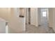 Open hallway with carpet, white walls, and easy access to the laundry room, bedroom, and other living spaces at 5398 Robinera Ct, Las Vegas, NV 89166