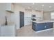 Modern kitchen featuring a large island with a sink, stainless steel appliances, and lots of natural light at 5398 Robinera Ct, Las Vegas, NV 89166