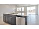 Modern kitchen island with stainless steel sink, dishwasher, and ample countertop space at 5398 Robinera Ct, Las Vegas, NV 89166