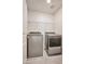 This laundry room includes modern washer and dryer units with handy overhead shelving at 5398 Robinera Ct, Las Vegas, NV 89166