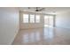 Bright and airy living room with tile flooring, neutral walls, and access to the patio at 5398 Robinera Ct, Las Vegas, NV 89166