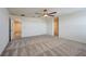 Large living room featuring neutral walls, carpet flooring, and versatile open layout at 5398 Robinera Ct, Las Vegas, NV 89166