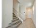 Carpeted staircase leading to the upper level of the home with a white handrail at 5398 Robinera Ct, Las Vegas, NV 89166
