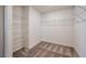 Walk-in closet featuring carpet, built-in shelving for organized storage at 5398 Robinera Ct, Las Vegas, NV 89166