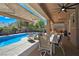 Outdoor patio with a seating area overlooking a swimming pool and backyard landscaping at 5416 Alabaster Ct, Las Vegas, NV 89149