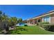 Lush backyard with pool, patio, and artificial turf, creating a serene outdoor oasis at 5416 Alabaster Ct, Las Vegas, NV 89149