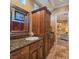 Bathroom vanity featuring granite countertops, and a framed mirror at 5416 Alabaster Ct, Las Vegas, NV 89149