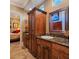 Bathroom vanity with granite countertops, wood cabinets and a decorative mirror at 5416 Alabaster Ct, Las Vegas, NV 89149