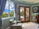 Bedroom with stylish armchair and French doors overlooking a pool at 5416 Alabaster Ct, Las Vegas, NV 89149