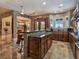 Kitchen with granite countertops, a large island with seating, and wooden cabinets with lots of natural light at 5416 Alabaster Ct, Las Vegas, NV 89149