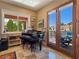 Elegant room with a black piano, and access to an outdoor terrace at 5416 Alabaster Ct, Las Vegas, NV 89149