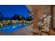 Inviting backyard pool at night, featuring well-maintained landscaping and covered patio area at 5416 Alabaster Ct, Las Vegas, NV 89149