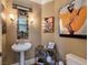Stylish powder room with a unique mirror and artwork at 5416 Alabaster Ct, Las Vegas, NV 89149