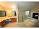 Bright bathroom featuring a corner jacuzzi tub, a shower with glass doors and double sinks at 5808 Amber Station Ave, Las Vegas, NV 89131