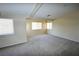 Spacious bedroom with multiple windows, vaulted ceiling with wood beams, and neutral carpeting at 5808 Amber Station Ave, Las Vegas, NV 89131