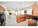 Well-equipped kitchen with wooden cabinets, granite countertops, stainless appliances, and island with breakfast bar at 5808 Amber Station Ave, Las Vegas, NV 89131