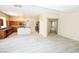 Open-concept kitchen featuring wood cabinets, granite countertops, stainless steel appliances, and breakfast bar at 5808 Amber Station Ave, Las Vegas, NV 89131