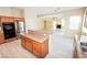 Spacious kitchen featuring wood cabinets, granite countertops, stainless steel appliances, and open to living area at 5808 Amber Station Ave, Las Vegas, NV 89131