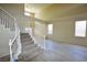 Elegant stairway leading to a spacious living room with wood tile flooring and neutral color palette at 5808 Amber Station Ave, Las Vegas, NV 89131