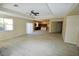 Open-concept living room featuring light wood-look flooring, ceiling fan, and seamless flow into the kitchen at 5808 Amber Station Ave, Las Vegas, NV 89131