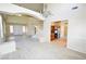 Spacious living room featuring tile floors, neutral tones, and ample natural light, staircase, and kitchen at 5808 Amber Station Ave, Las Vegas, NV 89131